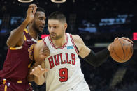 Chicago Bulls' Nikola Vucevic (9) drives against Cleveland Cavaliers' Evan Mobley (4) in the first half of an NBA basketball game, Wednesday, Dec. 8, 2021, in Cleveland. (AP Photo/Tony Dejak)