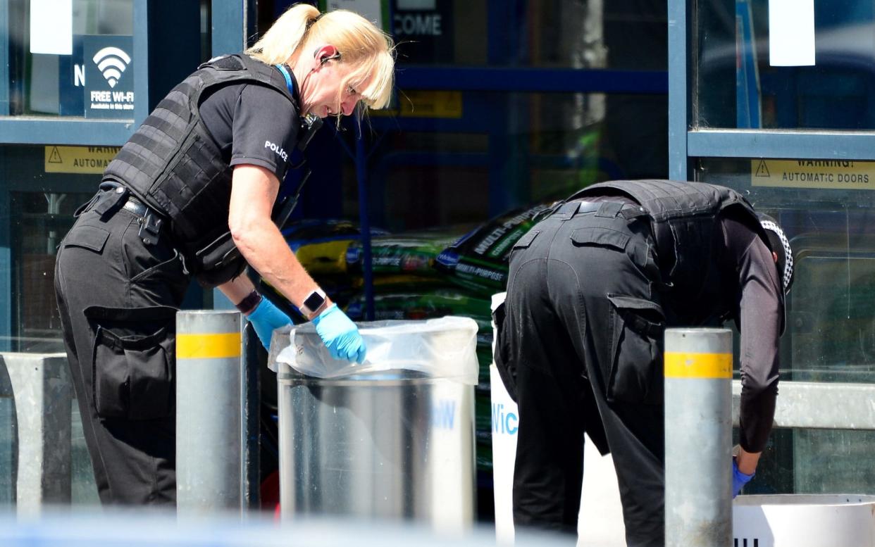 Police outside the Home Bargains store where the boy suffered injuries to his face and arm - SWNS.com