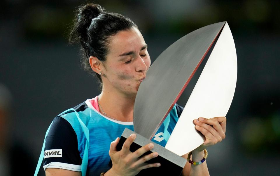 Ons Jabeur kisess the winner's trophy at the end of the women's final at the Madrid Open tennis tournament in Madrid, Spain, Saturday, May 7, 2022. Jabeur willl compete in the 2022 Wimbledon tennis tournament - Manu Fernandez/AP