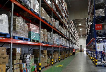 Employees work at RedMart's fulfillment centre in Singapore September 22, 2017. Picture taken September 22, 2017. REUTERS/Edgar Su