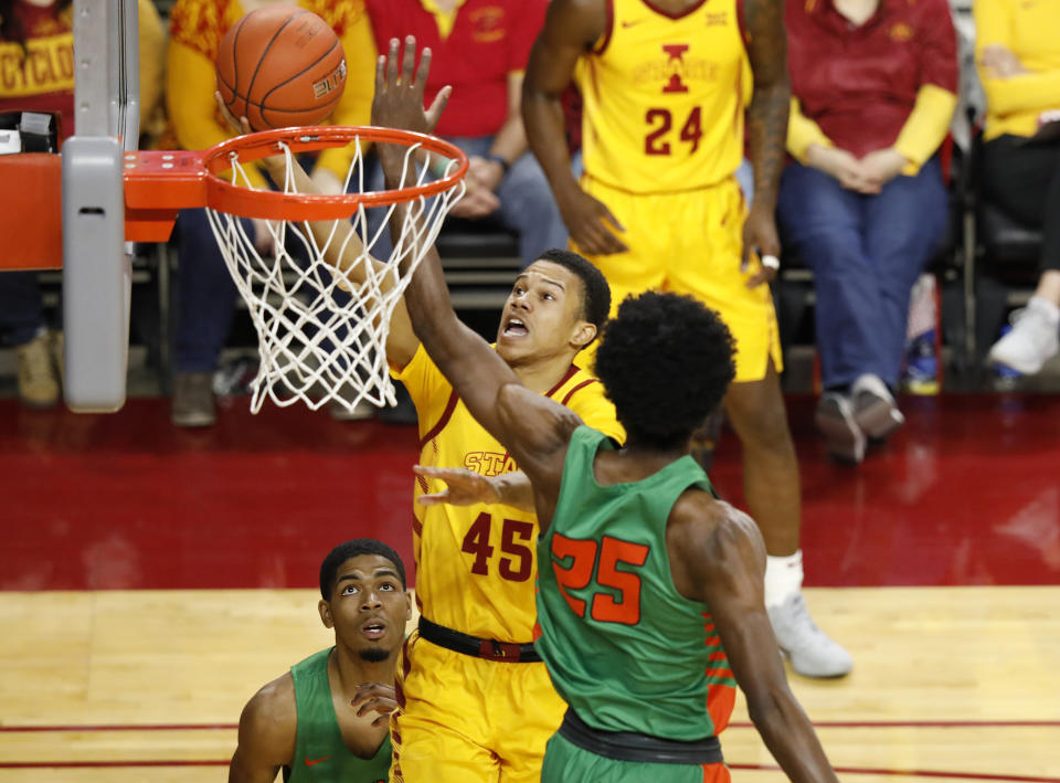 Iowa State guard Rasir Bolton, center, goes up between Florida A&M guard Brendon Myles, left, and forward DJ Jones, right, for a shot during the second half of an NCAA college basketball game Tuesday, Dec. 31, 2019, in Ames, Iowa. Florida A&M won 70-68. (AP Photo/Matthew Putney)