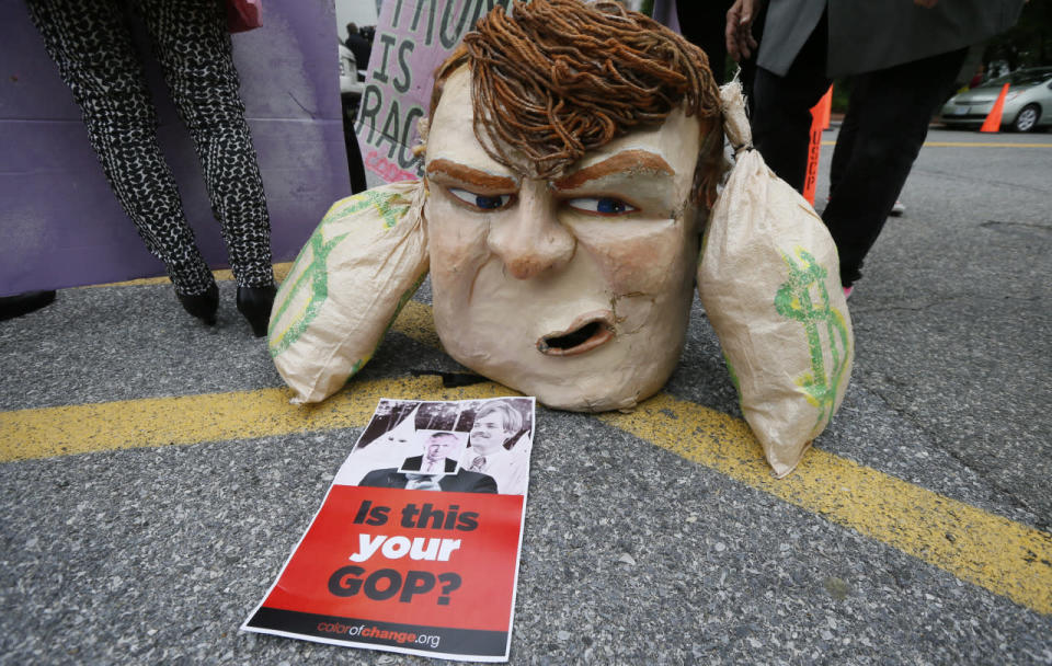 An anti-Trump mask and sign sit outside Republican National Committee (RNC) headquarters, where Republican U.S. presidential candidate Donald Trump was meeting with House Speaker Paul Ryan (R-WI) and RNC Chairman Reince Priebus in Washington, U.S., May 12, 2016.  (Jim Bourg/Reuters)