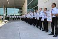 FILE - Southwest Airlines pilots picket outside the terminal at Dallas Love Field on June 21, 2022, in Dallas. As food costs and fuel bills soar, inflation is plundering people’s wallets, sparking a wave of protests and workers’ strikes around the world.(AP Photo/David Koenig)