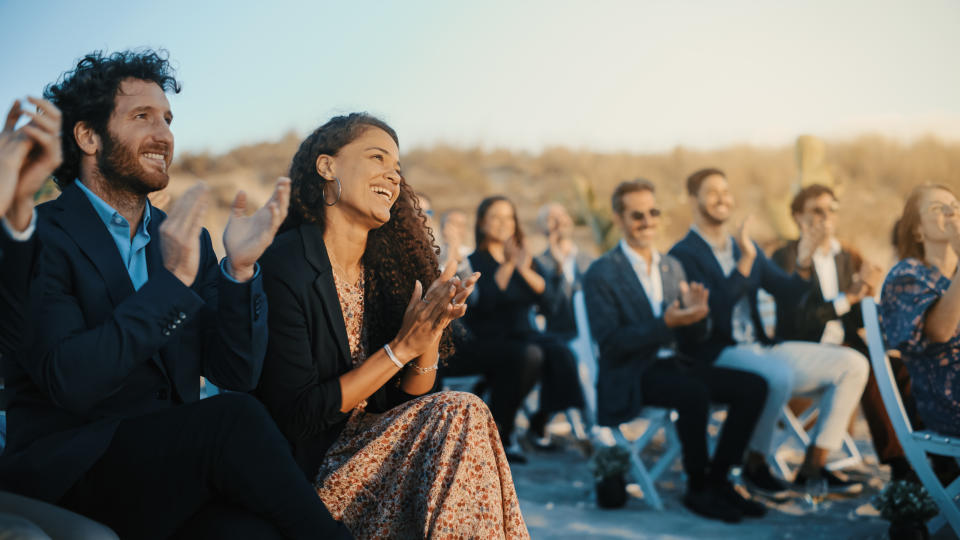 Excited Guests Sitting in an Outdoors Venue and Clapping Hands