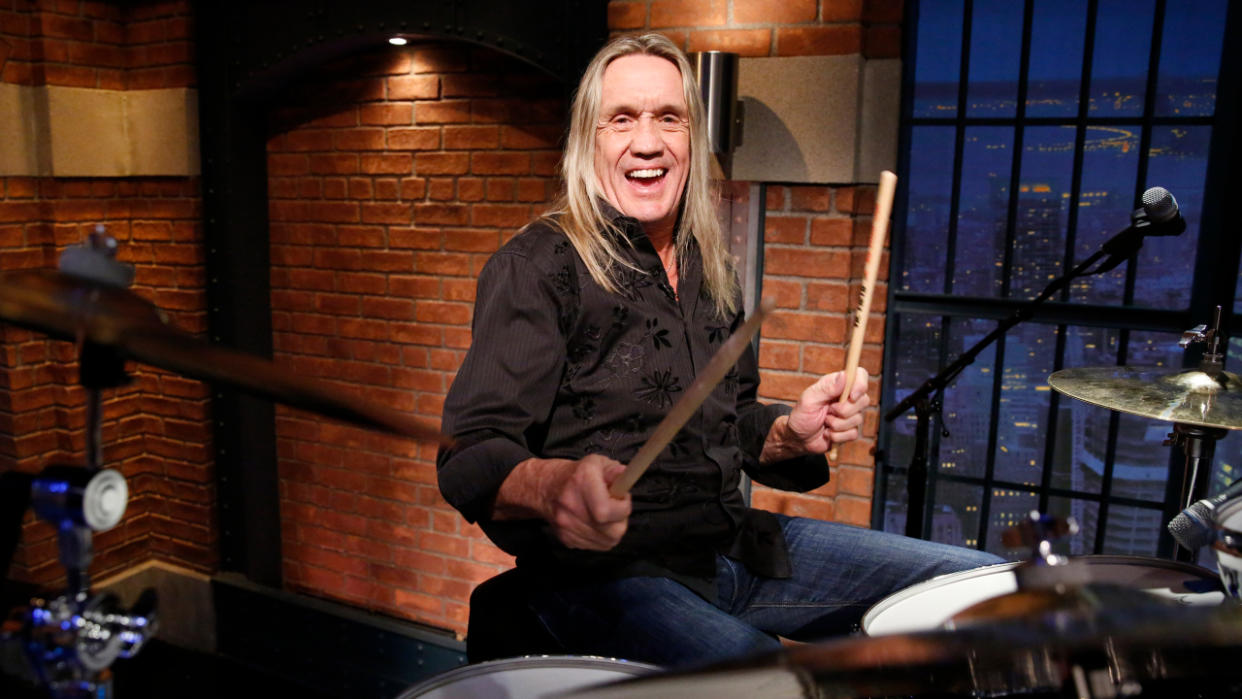  Nicko McBrain behind a drum kit. 