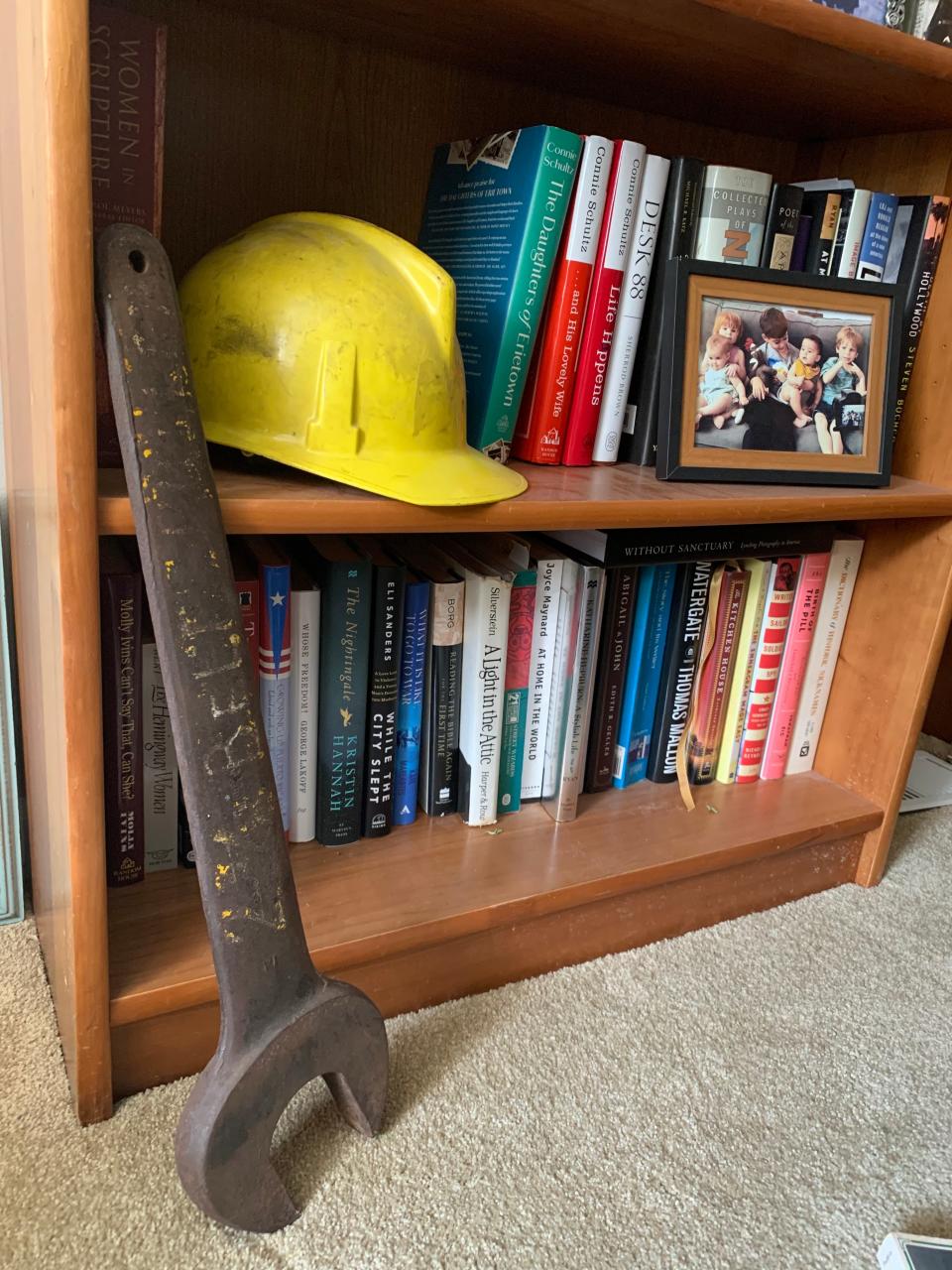 Connie Schultz keeps in her home office the worn hard hat and 11-pound wrench her father used as a utility worker at a power plant. The items, gifts from one of his supervisors, are on a low shelf so her grandchildren can see them and next to her books as a thank-you to her father.