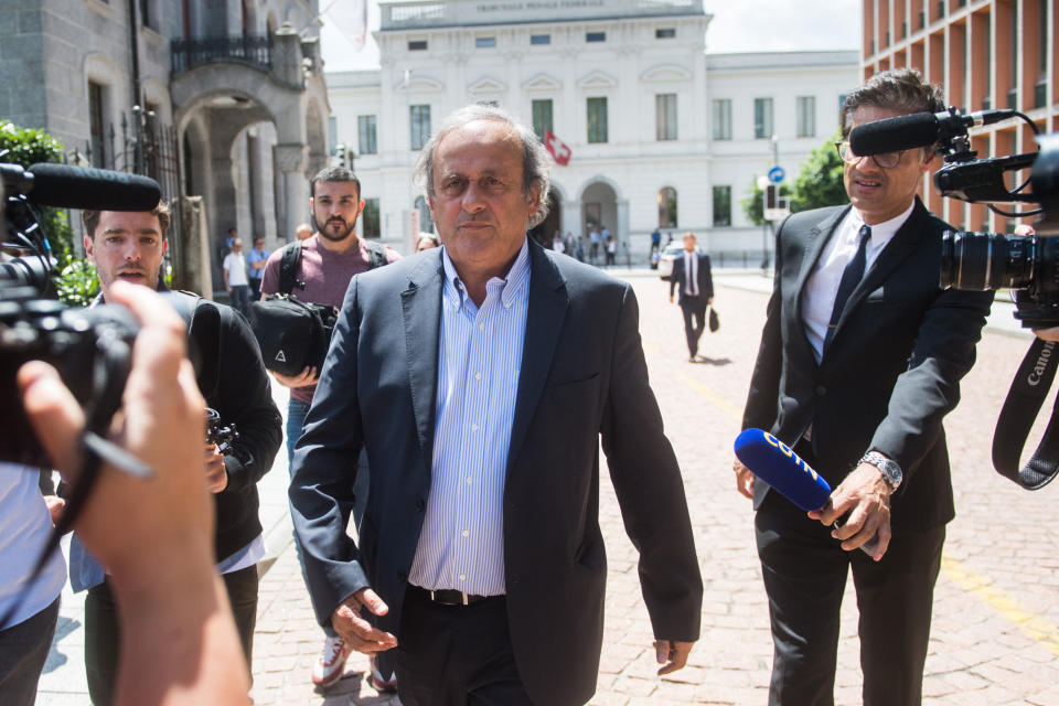 The former president of the the European Football Association (Uefa) Michel Platini, center, is leaving the Swiss Federal Criminal Court in Bellinzona, Switzerland, after the first day of his trial, Wednesday, June 8, 2022. Platini and the former president of the World Football Association (Fifa), Joseph Blatter, stand trial before the Federal Criminal Court from Wednesday, over a suspicious two-million payment. The Federal Prosecutor's Office accuses them of fraud. The defense speaks of a conspiracy. (Ti-Press/Alessandro Crinari/Keystone via AP)