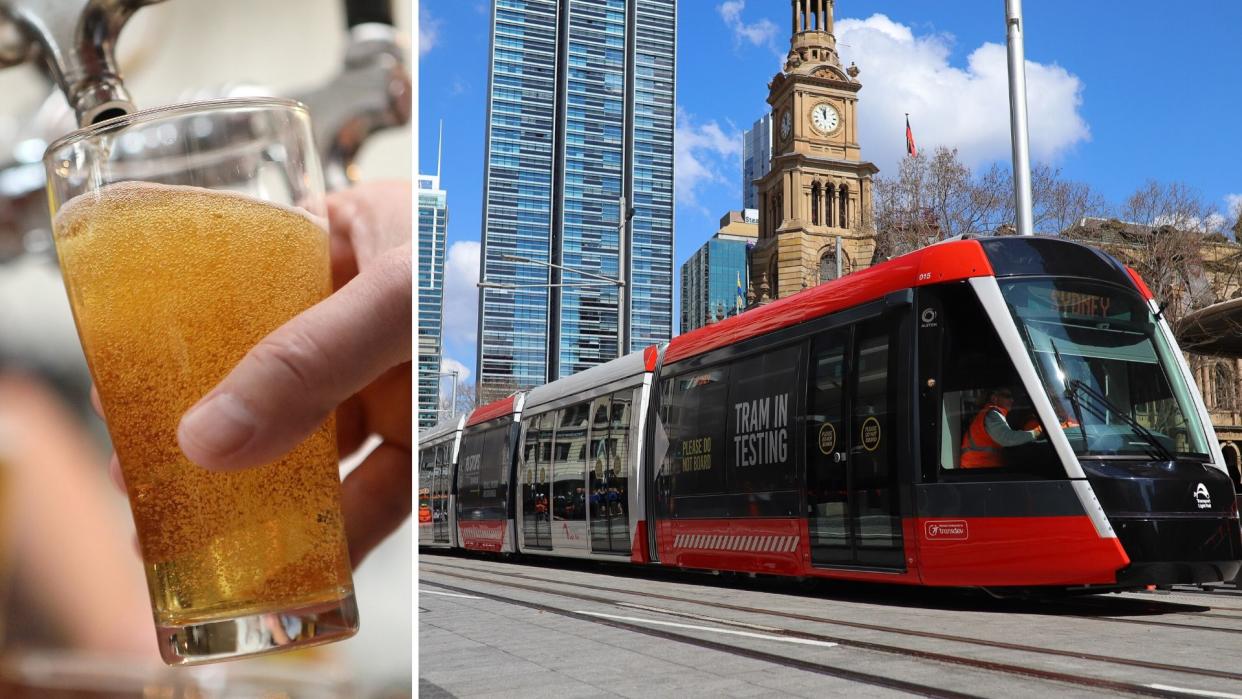 A glass of beer on the left and a new Sydney tram running down George St on the right.