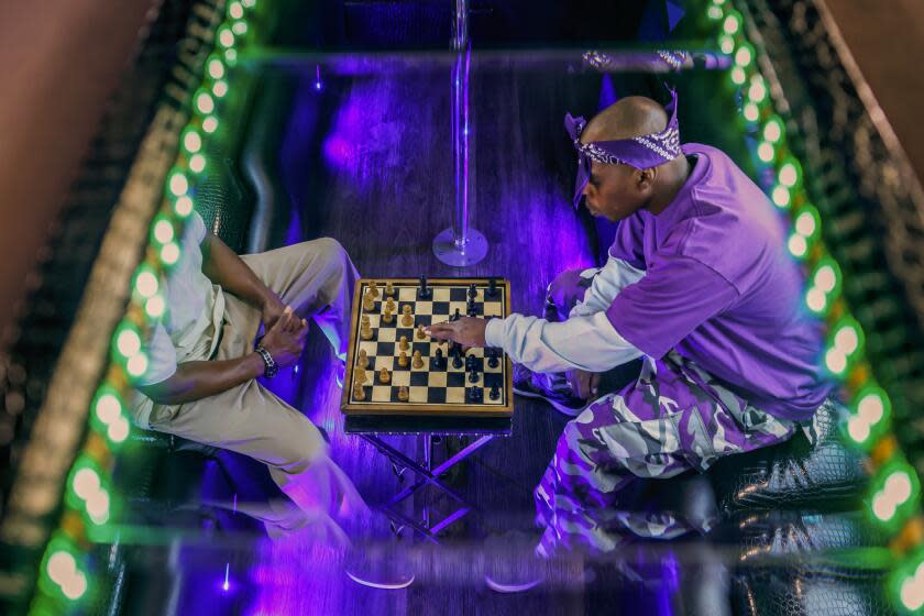 Vincent Hubbard plays chess inside a friend's party bus in South Central.