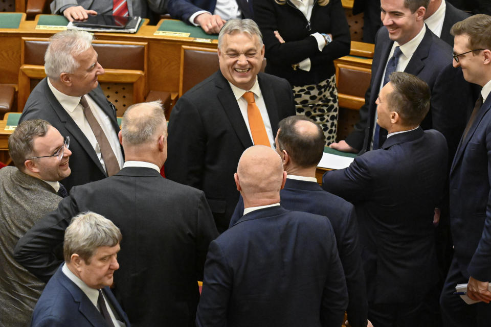 Hungarian Prime Minister Viktor Orban shares a laugh with lawmakers after Tamas Sulyok, was sworn in as the country's new President in a parliament session, in Budapest, Hungary, Monday, Feb 26, 2024. Hungary's former president, Katalin Novak, stepped down in February, over a pardon she issued to an accomplice in a child sexual abuse case.(AP Photo/Denes Erdos)