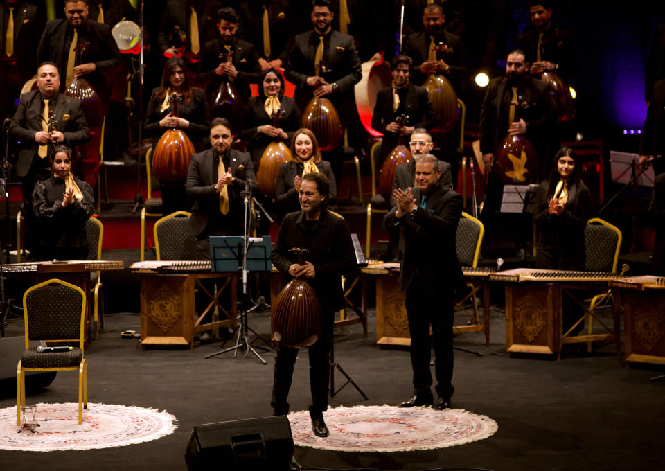 Iraqi virtuoso oud player Naseer Shamma receives a welcome at the Iraqi National Theater in Baghdad, Iraq, Friday, Jan. 21, 2022. War kept him away from his beloved homeland for decades. Now Shamma has returned to Iraq with a series of concerts and projects he hopes will support education, culture and the arts in the conflict-scarred nation. (AP Photo/Hadi Mizban)