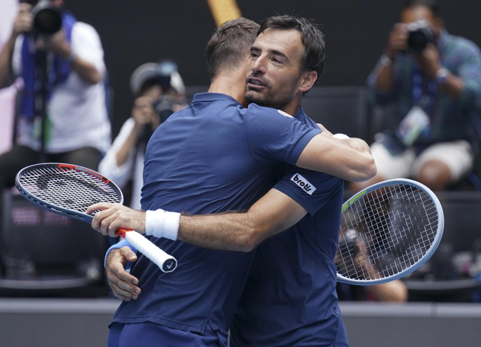 Croatia's Ivan Dodig, right, and Slovakia's Filip Polasek celebrate after defeating Rajeev Ram of the US and Britain's Joe Salisbury in the men's doubles final at the Australian Open tennis championship in Melbourne, Australia, Sunday, Feb. 21, 2021.(AP Photo/Mark Dadswell)