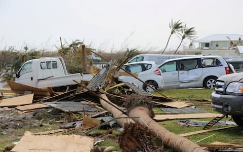 Damaged cars and trucks sit in a field following landfall by Hurricane Dorian, - Credit: Reuters