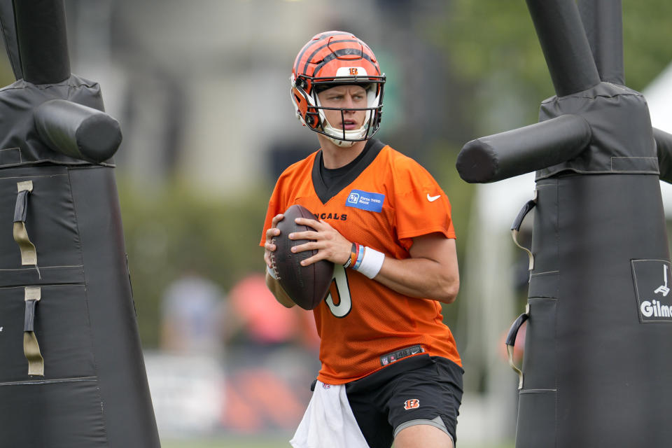 FILE - Cincinnati Bengals quarterback Joe Burrow (9) performs a drill during the NFL football team's training camp, Thursday, July 27, 2023, in Cincinnati. Burrow was back at practice on Wednesday, Aug. 30, 2023, more than a month after he was sidelined by strained right calf muscle.(AP Photo/Jeff Dean, File)