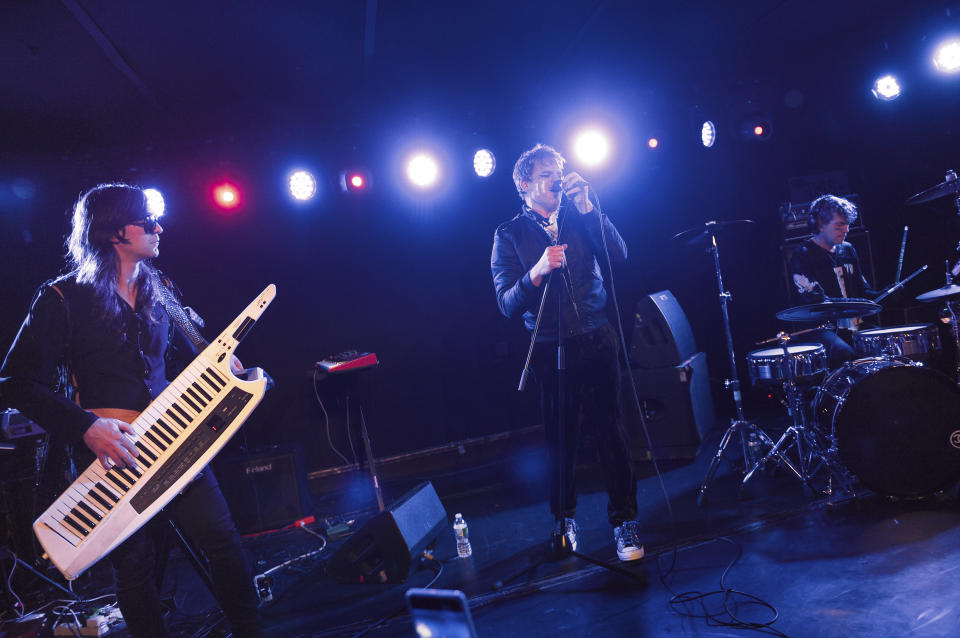 Actor and singer Michael C. Hall, center, multi-instrumentalist Matt Katz-Bohen, left, and drummer Peter Yanowitz of Princess Goes To The Butterfly Museum perform at the Mercury Lounge on Thursday, March 12, 2020, in New York. (Photo by Evan Agostini/Invision/AP)