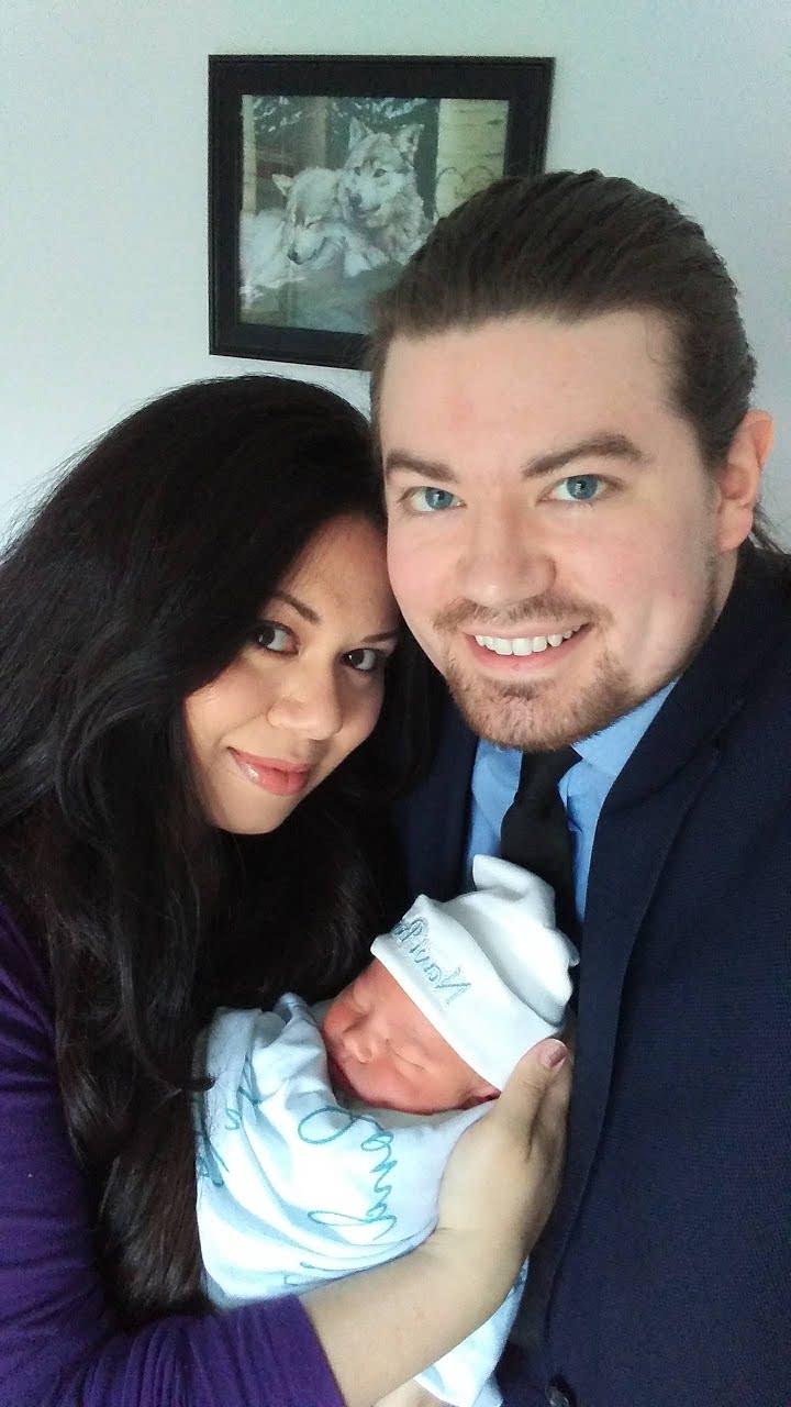 Sarah Rose and David Patrick pose with their newborn son, Navi Bond. (Photo: Patrick Family)