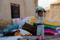 A Syrian boy stands near his house in the Al-Shallal suburb of Al-Hol in Syria's Hasakeh province after Syrian Democratic Forces re-took control of the area from the Islamic State group