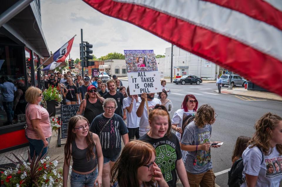 Holding signs of loved ones who died from fentanyl, activists march through downtown Leavenworth on Saturday, Sept. 16, 2023. The rally was held by parents who had lost children to fentanyl as a way to spread information about the dangers of the illicit drug.