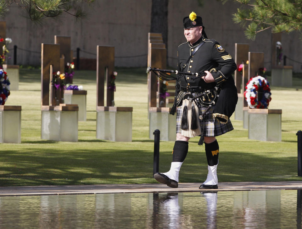 FILE - In this April 19, 2012 file photo, bagpiper Kevin M. Donnelly walks past the Field of Chairs during the 17th annual Remembrance Ceremony at the Oklahoma City National Memorial and Museum, in Oklahoma City. The attack on the U.S. Capitol by an angry mob of President Donald Trump's supporters shocked many Americans who thought such a violent assault by their fellow countrymen wasn't possible. But Timothy McVeigh's hatred of the federal government led him to bomb the Alfred P. Murrah Federal Building over 25 years earlier, on April 19, 1995, and killed 168 people. (AP Photo/Sue Ogrocki, Pool, File)