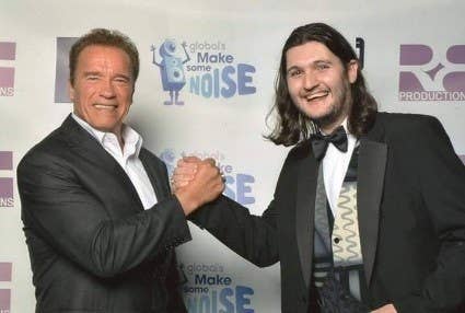 A man posing with a Arnold Schwarzenegger