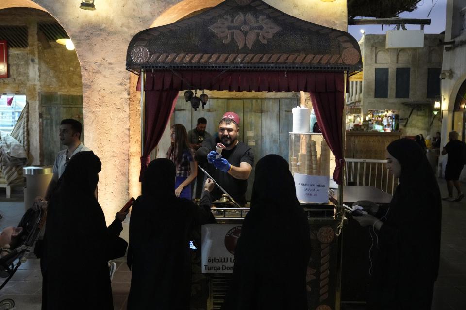 Women buy ice-cream at the Corniche, in Doha, Qatar, Wednesday, Nov. 23, 2022. (AP Photo/)