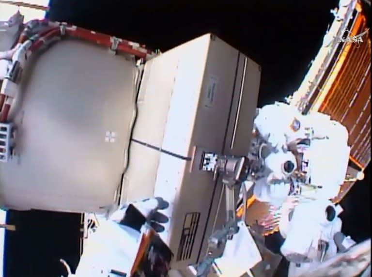 This NASA video grab shows astronauts Tim Kopra (L) and Tim Peake (R) as they replace a failed unit and equipment at the International Space Station on January 15, 2016