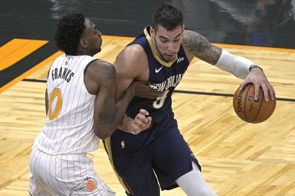 New Orleans Pelicans center Willy Hernangomez (9) drives to the basket as Orlando Magic forward Robert Franks (0) defends during the second half of an NBA basketball game Thursday, April 22, 2021, in Orlando, Fla. (AP Photo/Phelan M. Ebenhack)