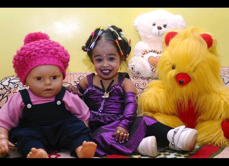 Indian Joyti Amge, alleged world's shortest girl with a height of 22.8 inches, poses with her toys on the evening of her 17th birthday on December 15, 2010 in Nagpur. 