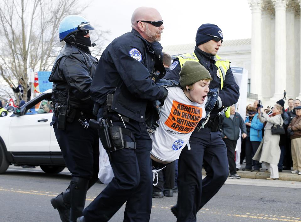 U.S. Capitol Police arrest pro-choice protesters for blocking the way of the anti-abortion March for Life at the U.S. Supreme Court building in Washington