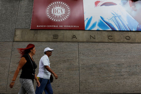 FILE PHOTO: People walk outside of the Venezuela's Central Bank in Caracas, Venezuela, January 31, 2018. REUTERS/Marco Bello/File Photo