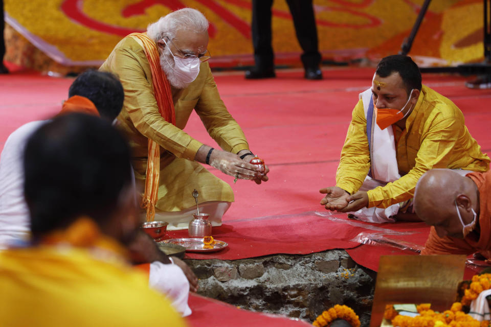 FILE- Indian Prime Minister Narendra Modi performs the groundbreaking ceremony of a temple dedicated to the Hindu god Ram, in Ayodhya, India, Aug. 5, 2020. Three decades after Hindu mobs tore down a historical mosque, Modi will attend the consecration of a grand Hindu temple at the same site on Monday in a political move to boost his party ahead of a crucial national vote. (AP Photo/Rajesh Kumar Singh, File)