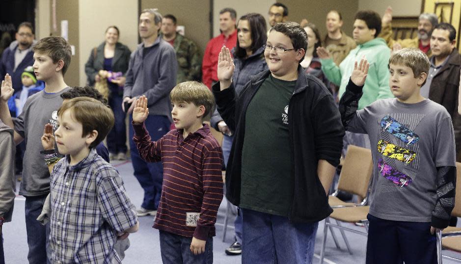 In this Tuesday, Feb. 4, 2014 photo, Trail Life members recite their organization's oath at the opening of meeting in North Richland Hills, Texas. The oath calls on the boys in part "to serve God and my country, to respect authority, and to be a good steward of creation." (AP Photo/LM Otero)