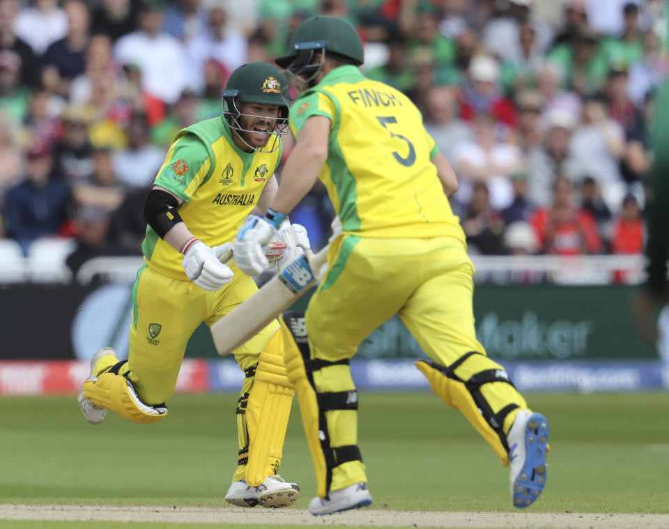 Australia's David Warner, left, and Australia's captain Aaron Finch run between wickets during the Cricket World Cup match between Australia and Bangladesh at Trent Bridge in Nottingham, Thursday, June 20, 2019. (AP Photo/Rui Vieira)