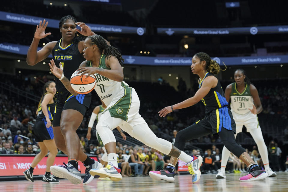 Seattle Storm guard Epiphanny Prince (11) drives against Dallas Wings center Teaira McCowan, left, during the first half of a WNBA basketball game, Tuesday, July 12, 2022 in Seattle. (AP Photo/Ted S. Warren)