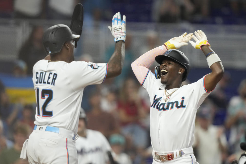 Miami Marlins' Jazz Chisholm Jr., right, celebrates with Jorge Soler (12) after hitting a grand slam during the third inning of a baseball game against the Atlanta Braves, Sunday, Sept. 17, 2023, in Miami. (AP Photo/Lynne Sladky)