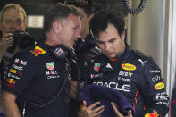 Red Bull Racing principal Christian Horner speaks with Red Bull driver Sergio Perez of Mexico following the third practice session for the Formula One Miami Grand Prix auto race at the Miami International Autodrome, Saturday, May 7, 2022, in Miami Gardens, Fla. (AP Photo/Darron Cummings)