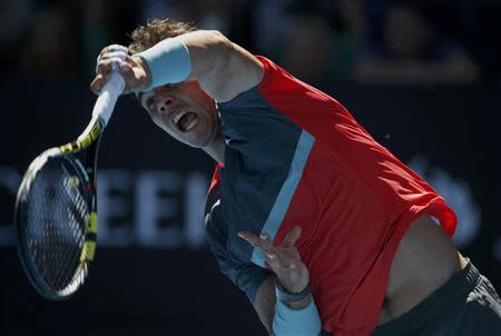 Rafael Nadal of Spain serves to Grigor Dimitrov of Bulgaria during their men's singles quarter-final tennis match at the Australian Open 2014 tennis tournament in Melbourne January 22, 2014. REUTERS/Jason Reed
