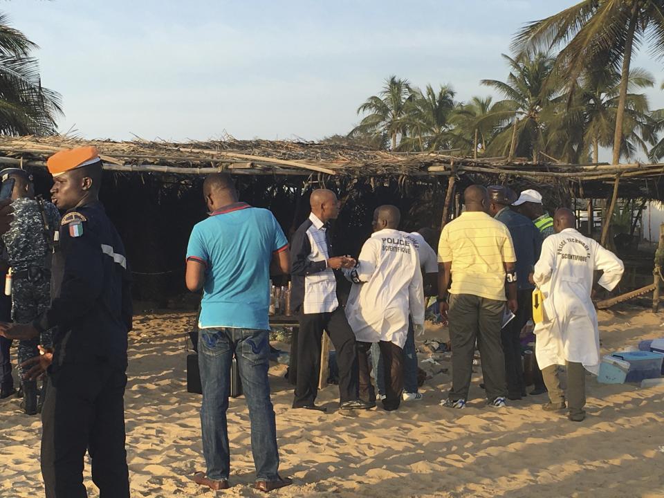 FILE - Security forces gather around the scene of an attack in Grand-Bassam, Ivory Coast, on March 13, 2016. Eleven people have been sentenced to life in prison in Ivory Coast on Wednesday Dec. 28, 2022 after being convicted of carrying out an Islamic extremist attack that killed 19 people and injured dozens more on a tourist beach nearly seven years ago. (AP Photo/Christin Roby, File)