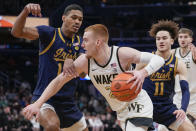 Notre Dame forward Tae Davis, left, and Notre Dame guard Braeden Shrewsberry, right, guard Wake Forest guard Cameron Hildreth, center, during the first half of an NCAA college basketball game in the second round of the Atlantic Coast Conference tournament, Wednesday, March 13, 2024, in Washington. (AP Photo/Susan Walsh)