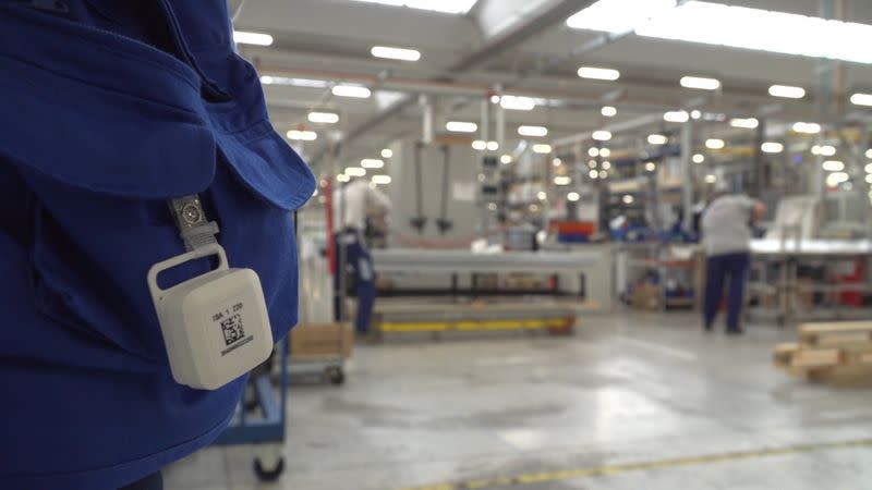 A tag using SWAT technology hangs from a pocket of a worker inside the ISA factory in Bastia Umbra