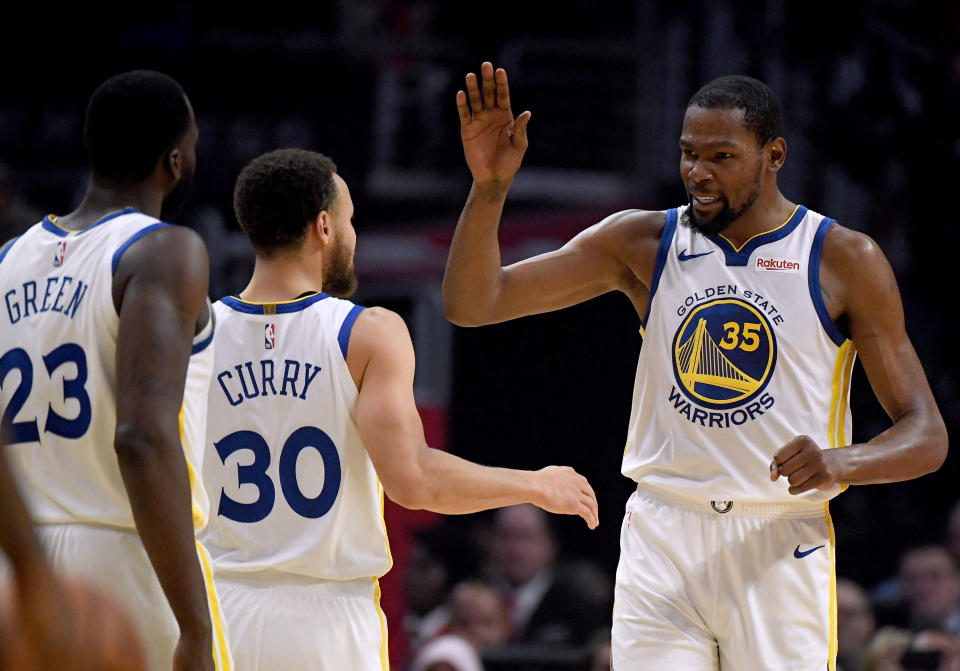 LOS ANGELES, CALIFORNIA - APRIL 26:  Kevin Durant #35 of the Golden State Warriors celebrates a double digit lead lead over the LA Clippers with Stephen Curry #30 and Draymond Green #23 in the first half during Game Six of Round One of the 2019 NBA Playoffs at Staples Center on April 26, 2019 in Los Angeles, California. (Photo by Harry How/Getty Images)  NOTE TO USER: User expressly acknowledges and agrees that, by downloading and or using this photograph, User is consenting to the terms and conditions of the Getty Images License Agreement.