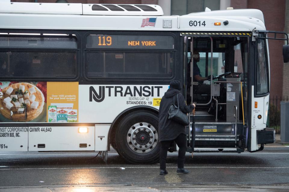 A woman boards the 119 NJ Transit Bus on the corner of J.F. Kennedy Blvd and McAdoo Ave in Jersey City, N.J. on Wednesday April 6, 2022. 