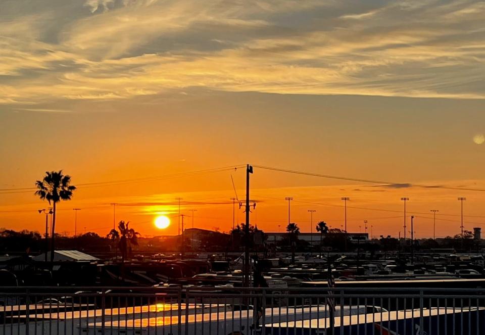 The sunrise over Turn 3 forecasts a warm day at Daytona.