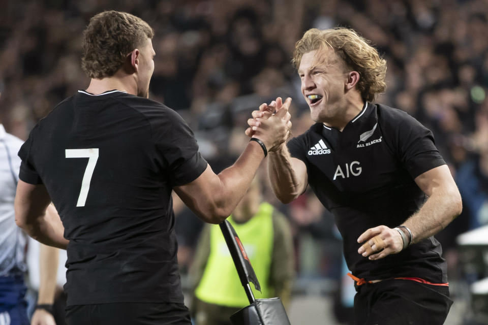 New Zealand's Dalton Papalii, left, congratulates teammate Damian McKenzie after he scored against Australia during their Bledisloe Cup rugby union test match at Eden Park in Auckland, New Zealand, Saturday, Aug. 7, 2021. (Brett Phibbs/Photosport via AP)