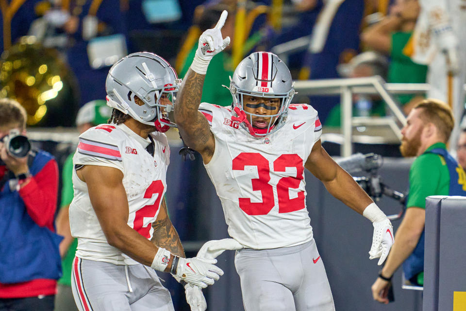 SOUTH BEND, IN - SEPTEMBER 23: Ohio State Buckeyes running back TreVeyon Henderson (32) celebrates with wide receiver Emeka Egbuka (2) and teammates after scoring a touchdown in action during a football game between the Notre Dame Fighting Irish and the Ohio State Buckeyes on September 23, 2023 at Notre Dame Stadium in South Bend, IN. (Photo by Robin Alam/Icon Sportswire via Getty Images)