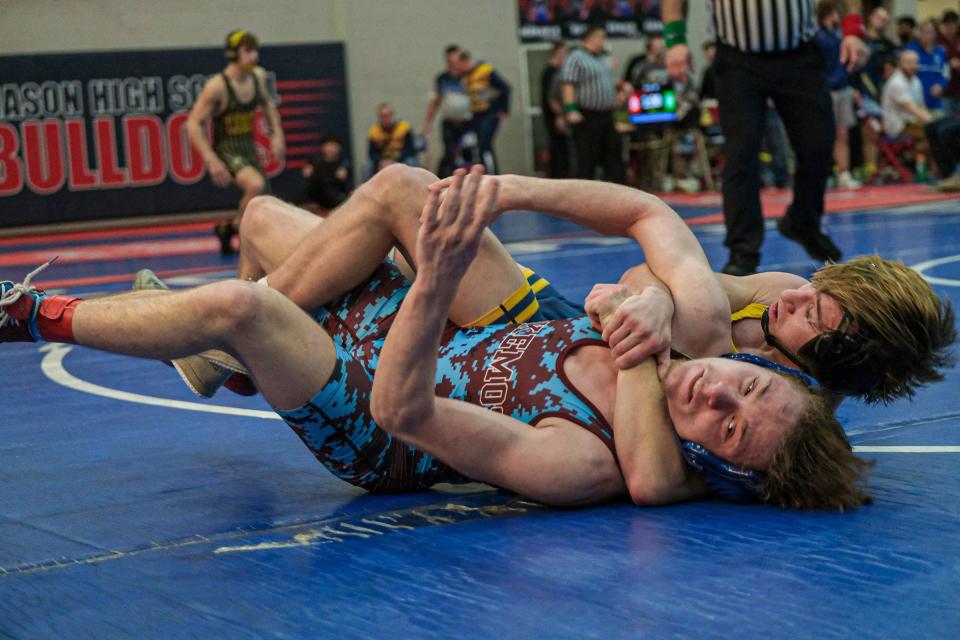Kaleb Smith-Baldwin, from Okemos, front, and Trenden Bashore from DeWitt grapple in the 132 weight class at the CAAC Wrestling Championships Saturday, Feb. 3, 2024.