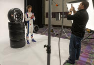 IndyCar driver Matheus Leist poses for a social media photo being taken by Keith Cawley during IndyCar auto racing media day, Monday, Feb. 11, 2019, in Austin, Texas. (AP Photo/Stephen Spillman)