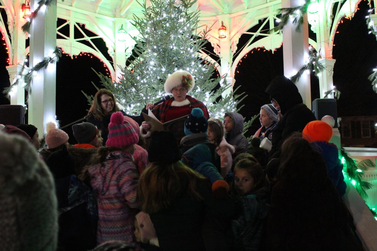 Mrs. Claus reads to a group of kids at the Yule Log and Tree Lighting Celebration in Bellville.