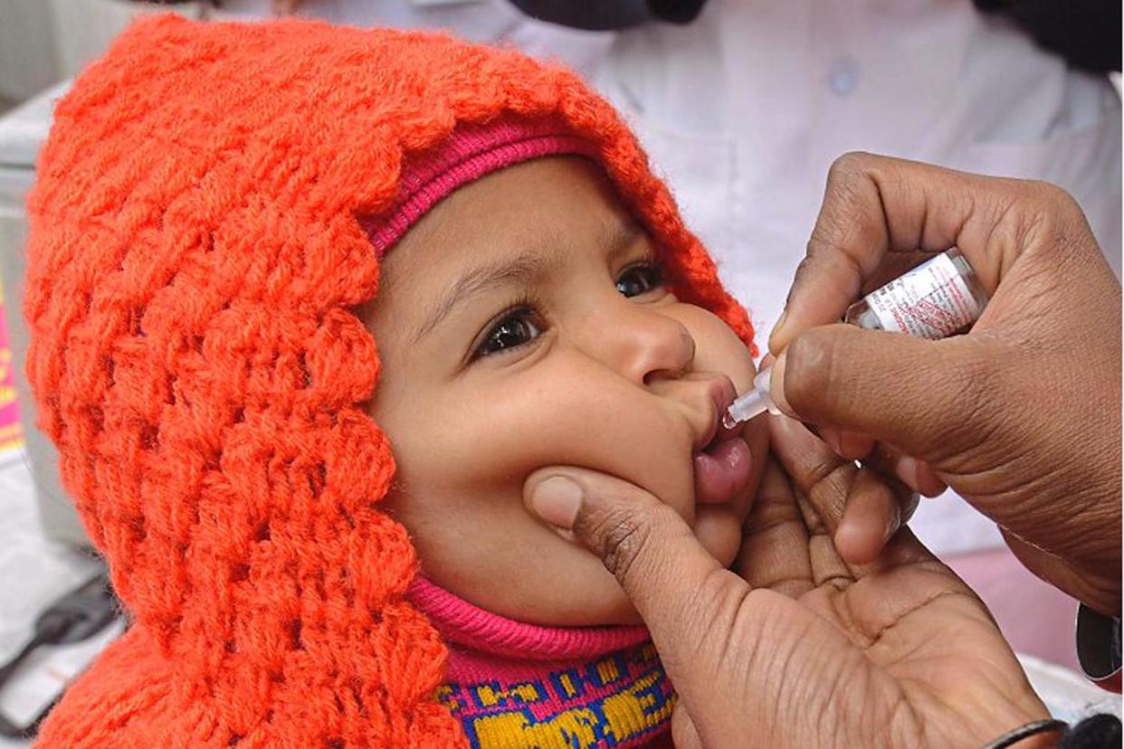 Little miracle: a child is given the polio vaccine in Amritsar, India. Research found a small change such as switching to mobile clinics helped vaccination rates shoot up: Getty Images