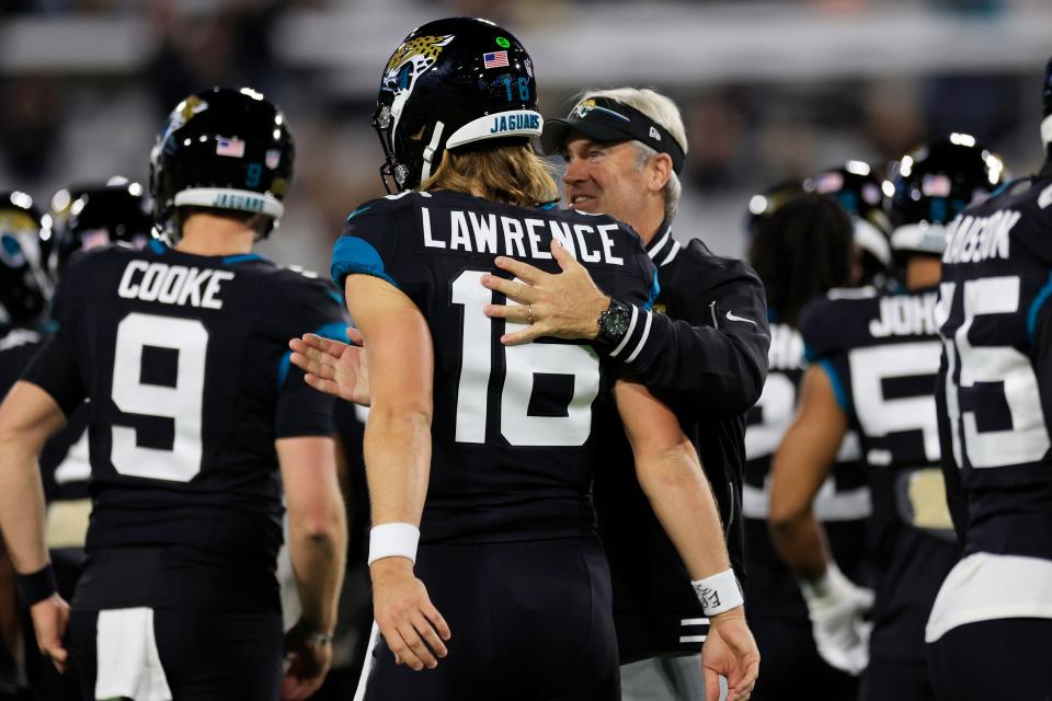 Jacksonville Jaguars quarterback Trevor Lawrence (16) is patted on the back by head coach Doug Pederson before a regular season NFL football matchup Monday, Dec. 4, 2023 at EverBank Stadium in Jacksonville, Fla. The Cincinnati Bengals defeated the Jacksonville Jaguars 34-31 in overtime. [Corey Perrine/Florida Times-Union]